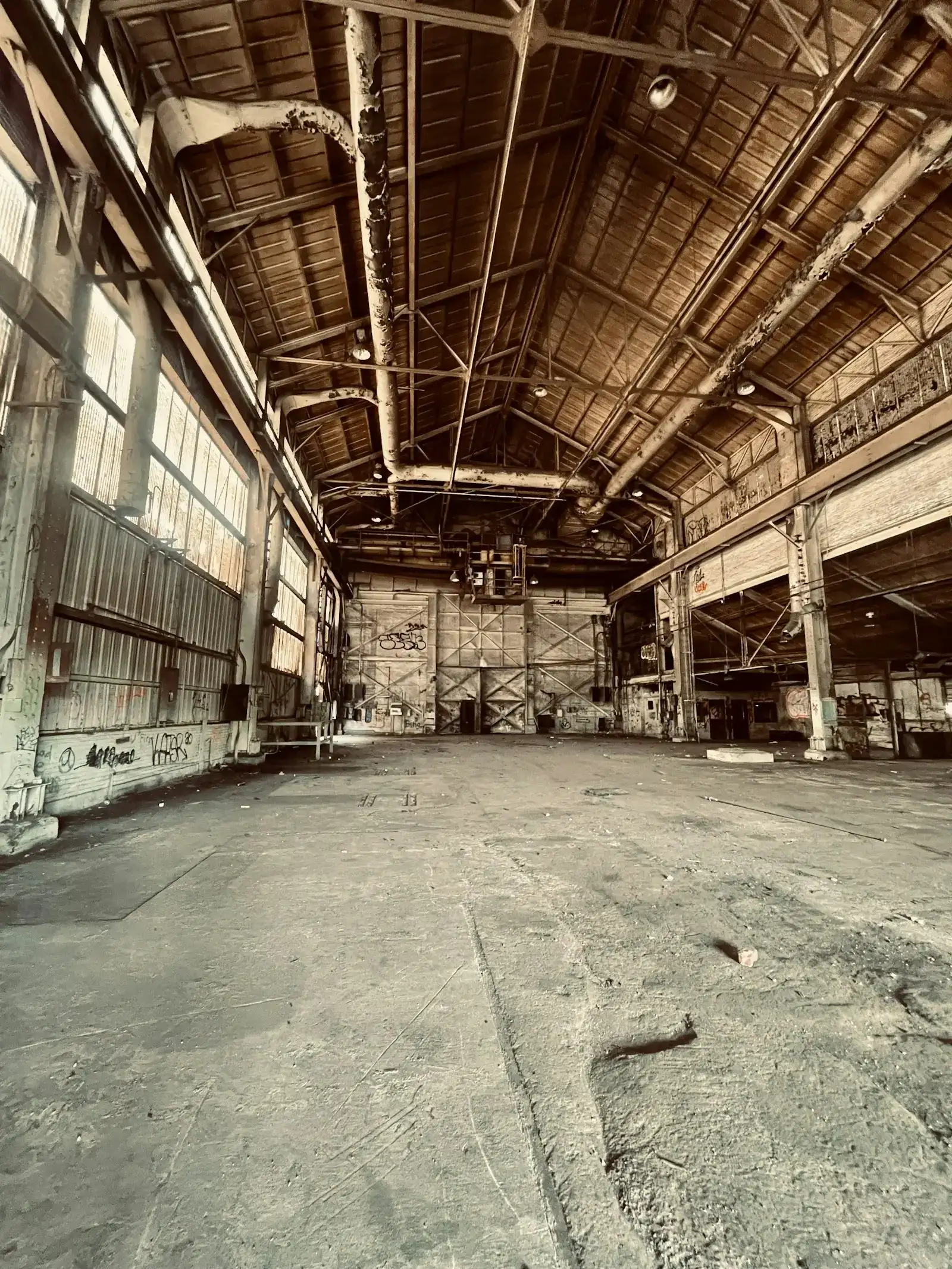 Interior of an older industrial building with exposed trusses